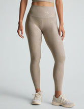 brown high-waisted midi length leggings with a star shine print.